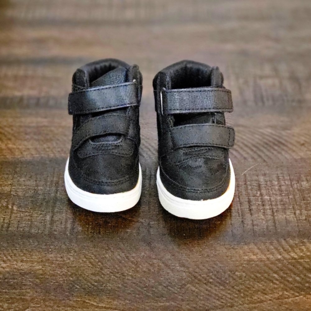 Children place all black sneakers